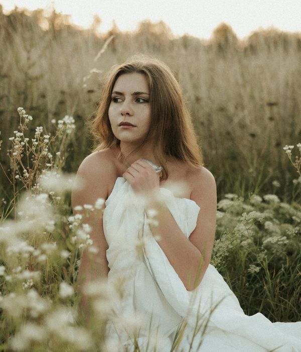 Person sitting in a calm, meditative pose with warm light accents.