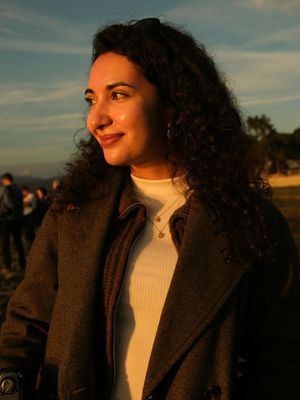 Portrait of a calm and friendly female instructor smiling slightly.
